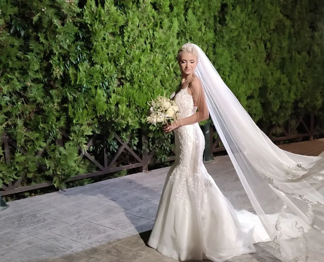 Bride in the green garden of the wedding estate