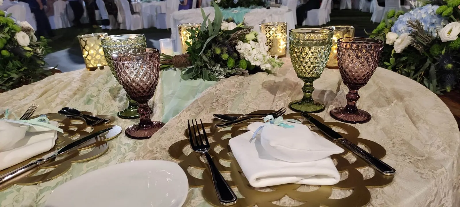 Reception table setting with coloured glassware