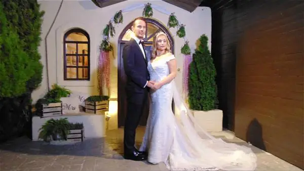 Bride and groom in front of the chapel
