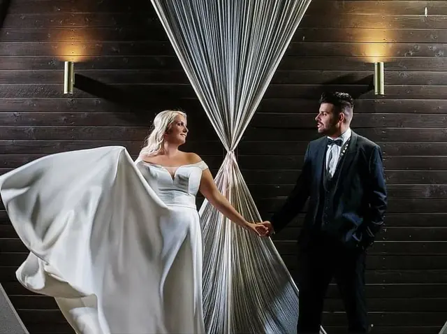 Bride and groom by a crystal curtain