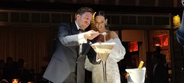 Bride and groom opening champagne