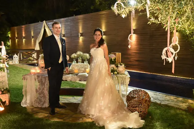 Bride and groom with the cake in the garden
