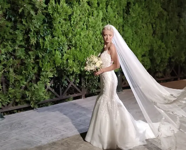 Bride in the green garden of the wedding estate
