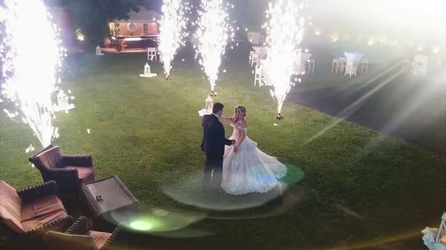 Couple dancing with fireworks in the garden